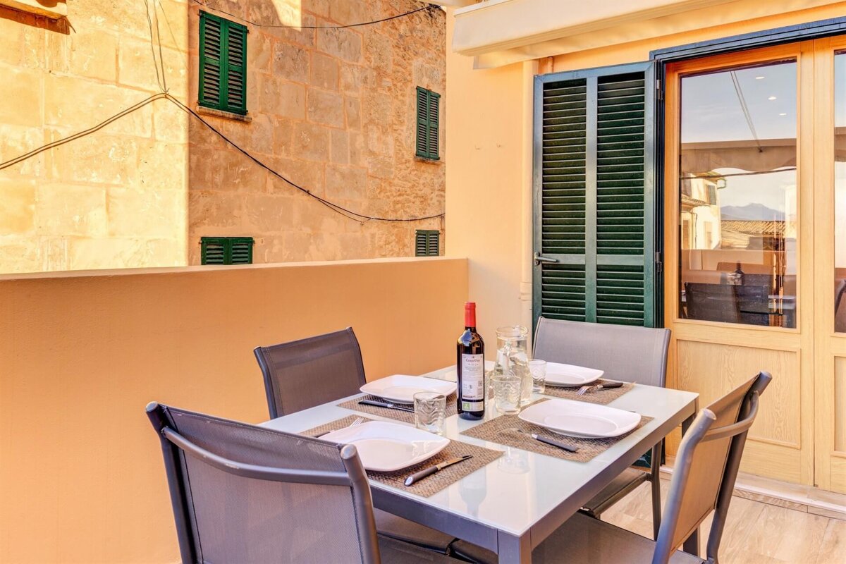 A table with plates and a bottle of wine on it