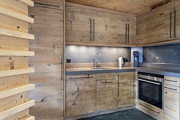 A kitchen with wooden cabinets and stainless steel appliances