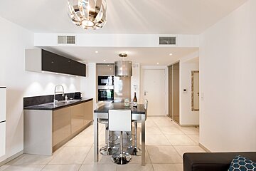 A kitchen with a table and chairs and a sink