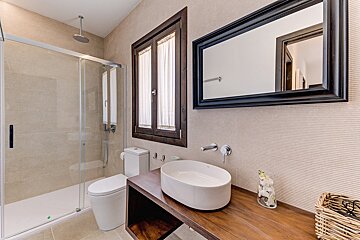 A bathroom with a toilet a sink and a mirror