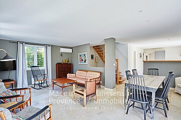 A living room with a table and chairs and the words made in provence