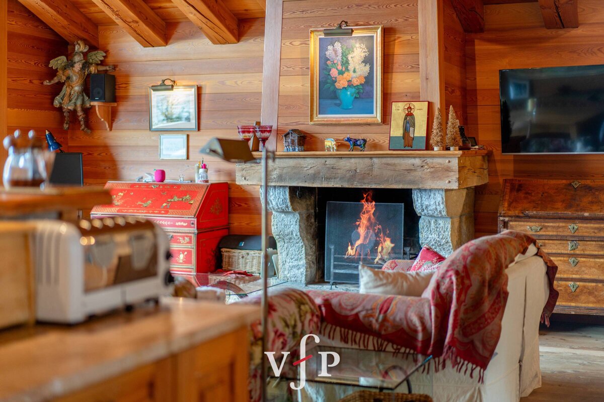 A living room with a fireplace and a vfp logo