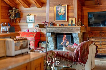A living room with a fireplace and a vfp logo