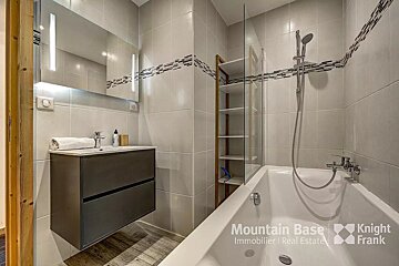 A bathroom with a bathtub and a sink from mountain base knight frank