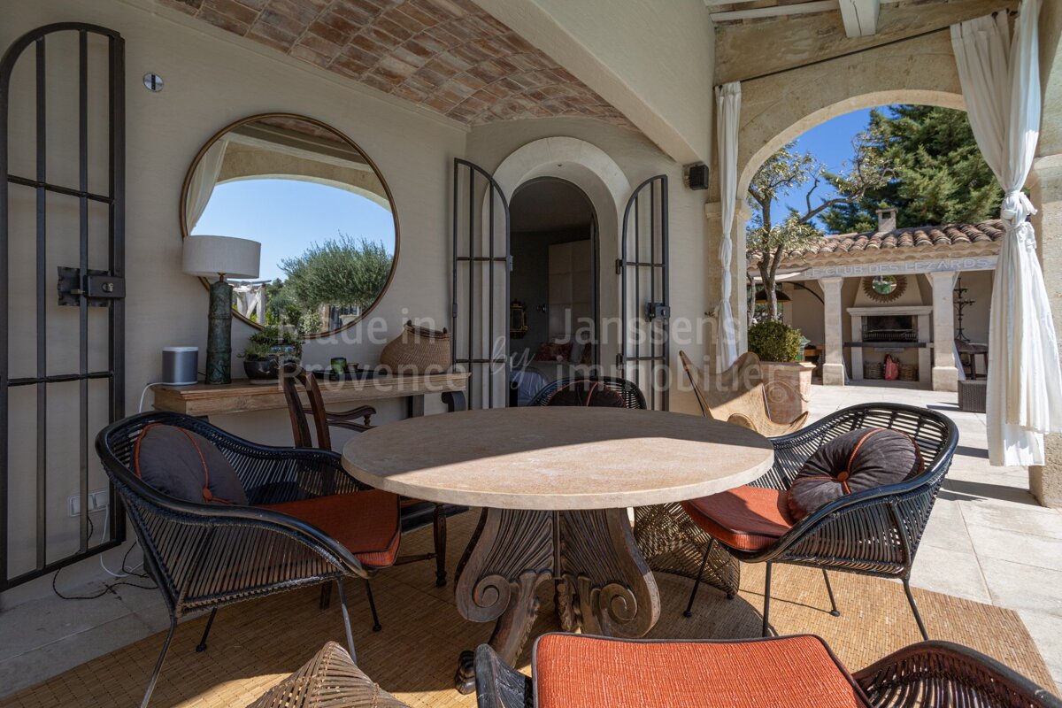 A patio with a table and chairs and a sign that says made in provence