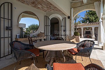 A patio with a table and chairs and a sign that says made in provence