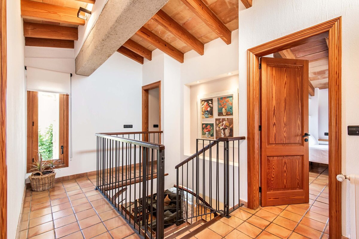 A hallway with a staircase leading up to the second floor