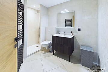 A bathroom with white management written on the wall