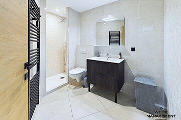 A bathroom with white management written on the wall
