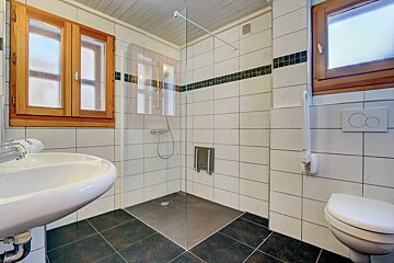 A bathroom with a walk in shower and a toilet