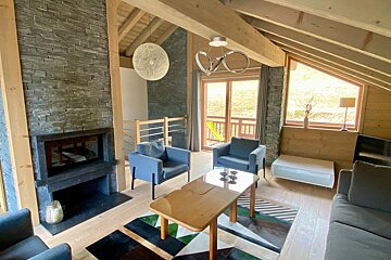A living room with a couch and chairs and a fireplace