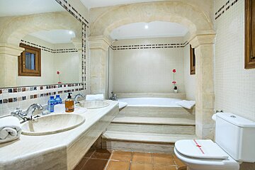 A bathroom with two sinks a toilet and a bathtub