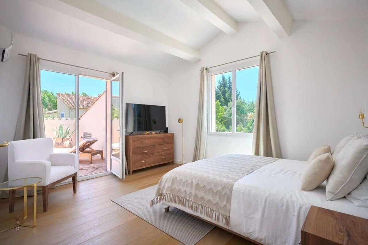 A bedroom with a large bed and a flat screen tv