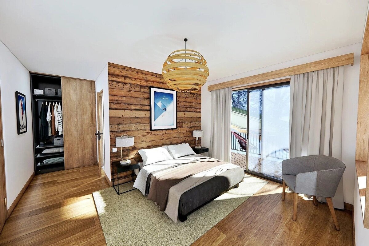 Chic, modern bedroom with a wooden accent wall, floor, and sliding door to a balcony. Features a bed, closet, and unique circular chandelier.