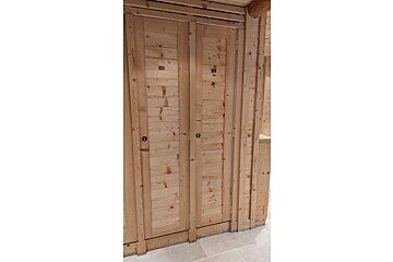 A wooden door with a black lock on it