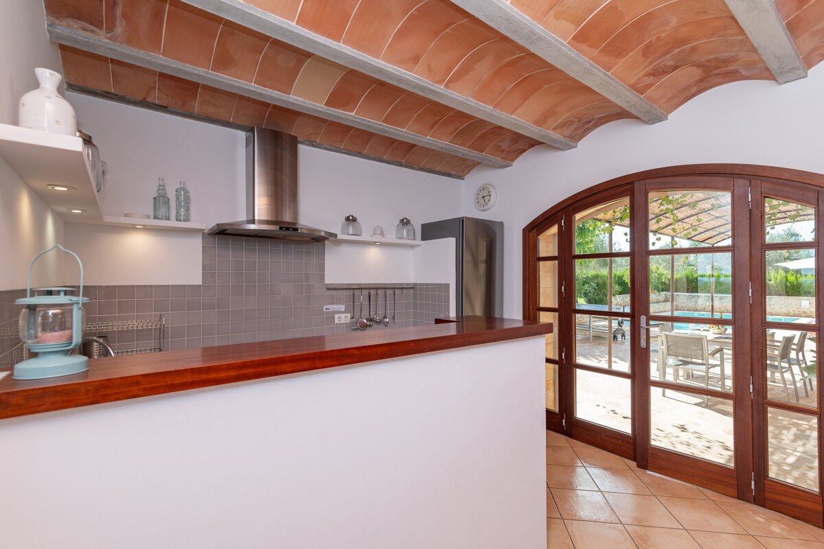 A kitchen with a stove top oven and a lantern on the counter