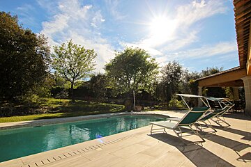 A swimming pool with a lot of chairs around it