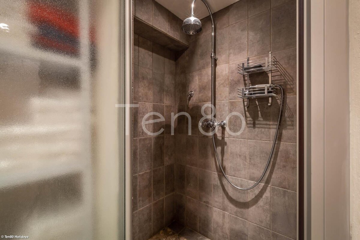 A shower with the word ten on the wall