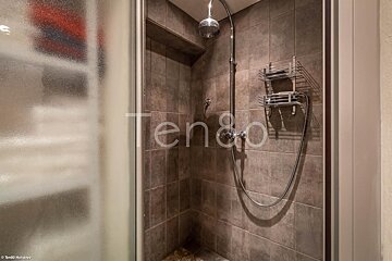 A shower with the word ten on the wall