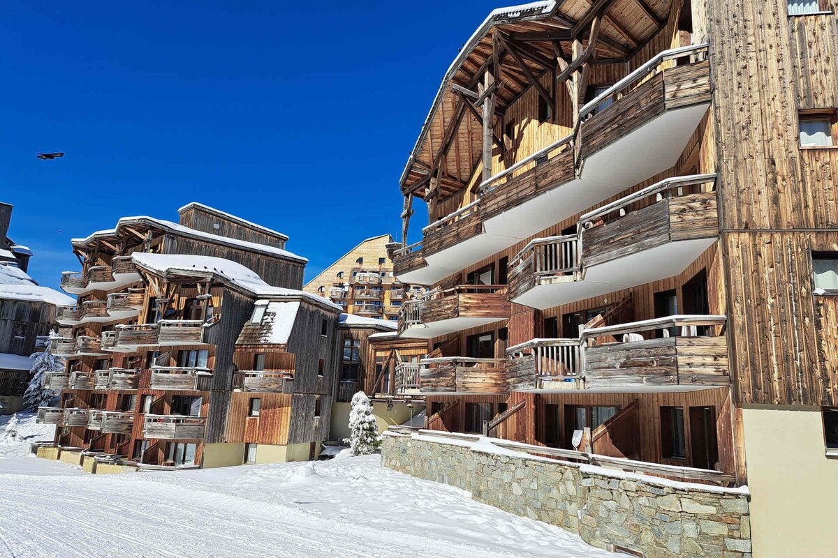A wooden building with a balcony in the snow