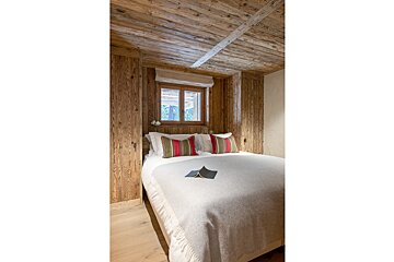 A bedroom with a bed and a book on it