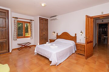 A bedroom with a large bed and two nightstands