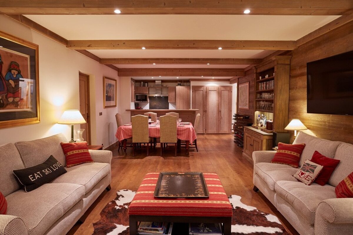 A living room with a couch that says eat ski love