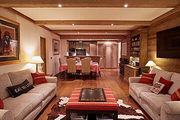 A living room with a couch that says eat ski love