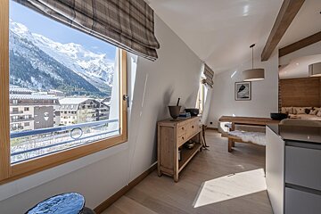 A living room with a view of the mountains