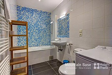 A bathroom with a washer and dryer from mountain base