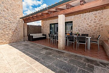 A patio with a table and chairs and a couch