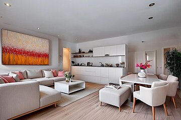 A living room with a large painting on the wall above the couch