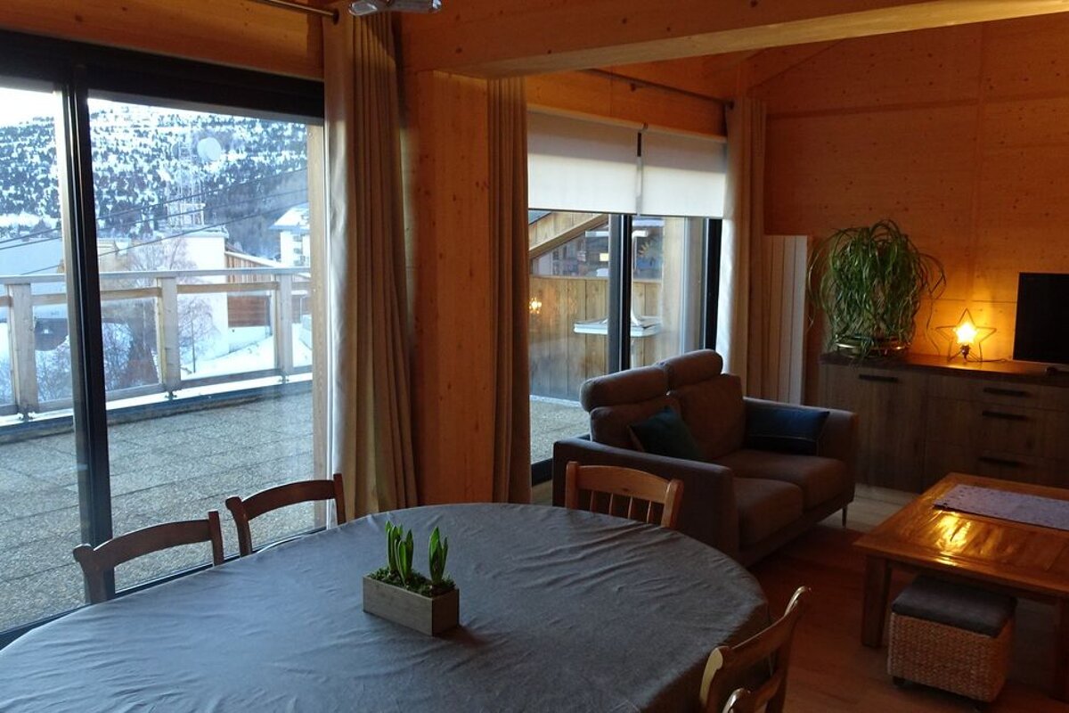 A living room with a table and chairs and a couch