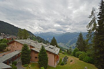 A view of a valley with mountains in the background