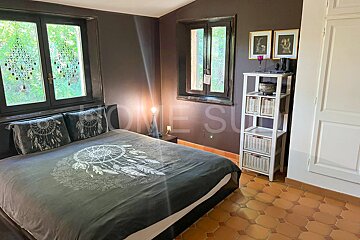 A bedroom with a bed that has a dream catcher on it
