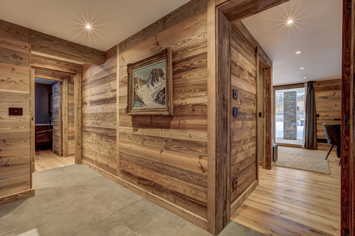 A hallway with wood paneling and a painting on the wall