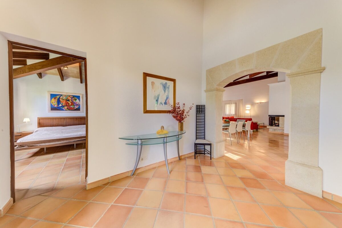 A hallway leading to a bedroom and a living room