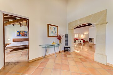 A hallway leading to a bedroom and a living room