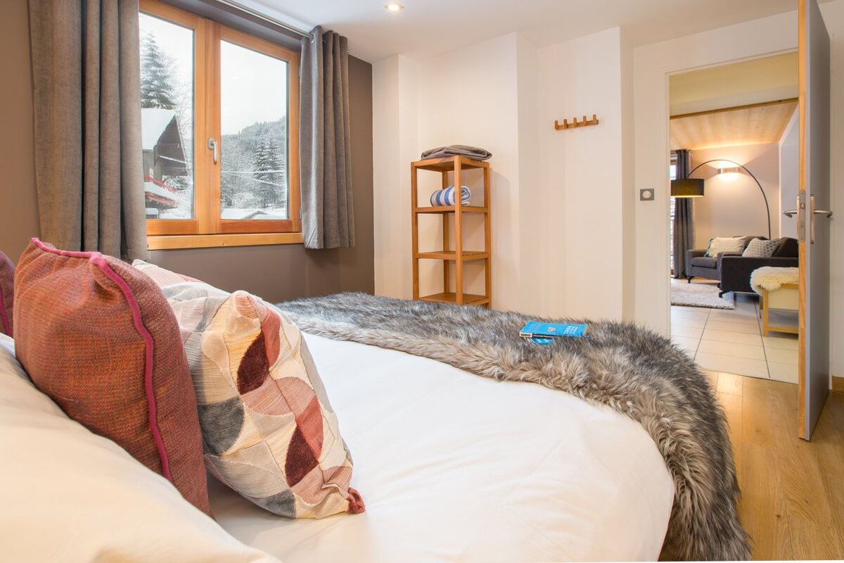 A bedroom with a bed and a book on it