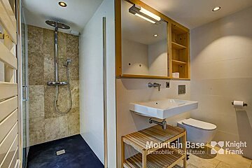 A bathroom with a knight frank logo on the wall