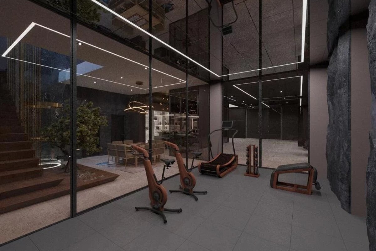 Sleek, luxury home gym featuring wooden exercise equipment, glass walls, and dark stone accents.
