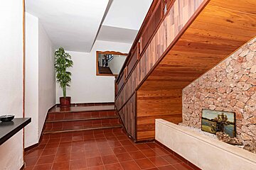A staircase with a picture of a ship on the wall