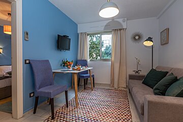 A living room with a couch a table and chairs