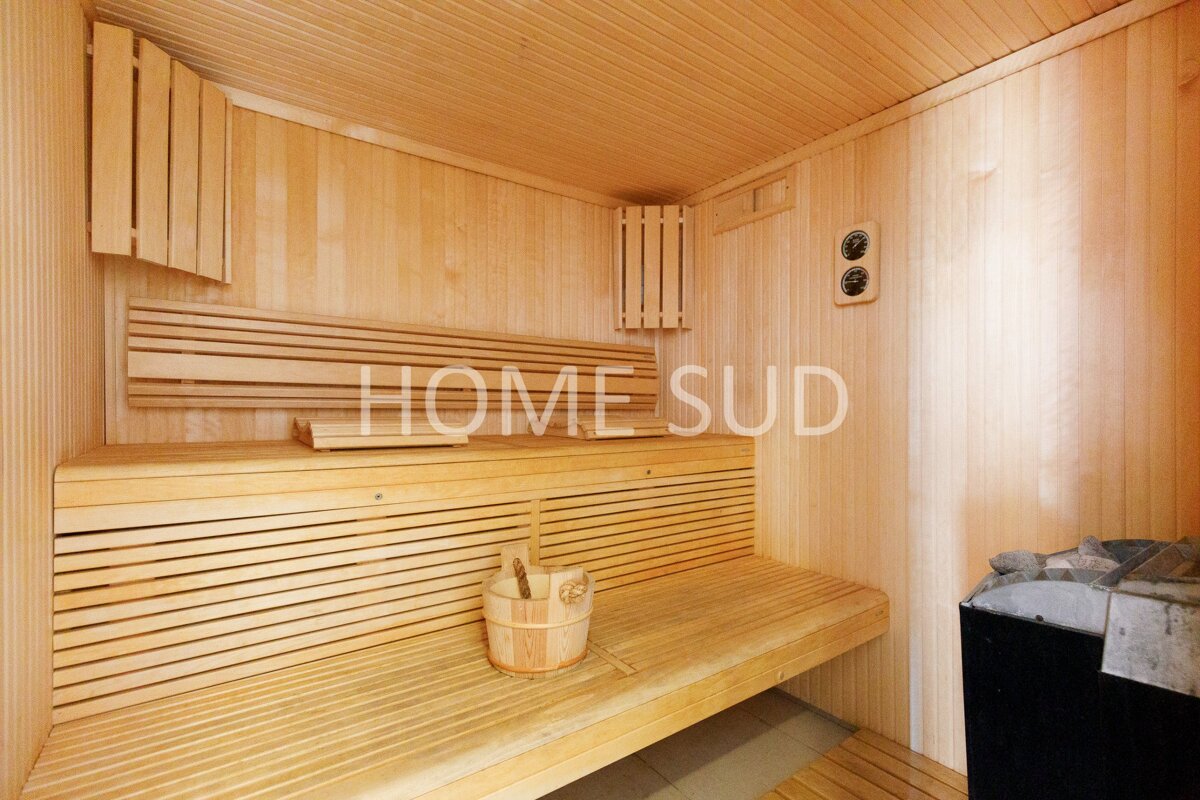 A wooden sauna with the word home sud on the wall