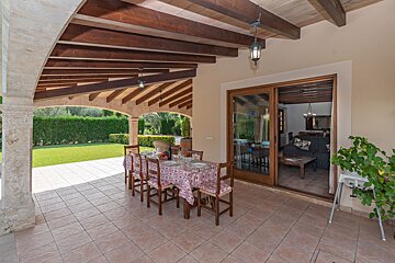 A patio with a table and chairs and a sliding glass door