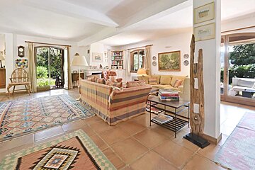 A living room with a couch a rug and a book on a table