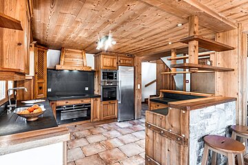 A kitchen with wooden cabinets and stainless steel appliances
