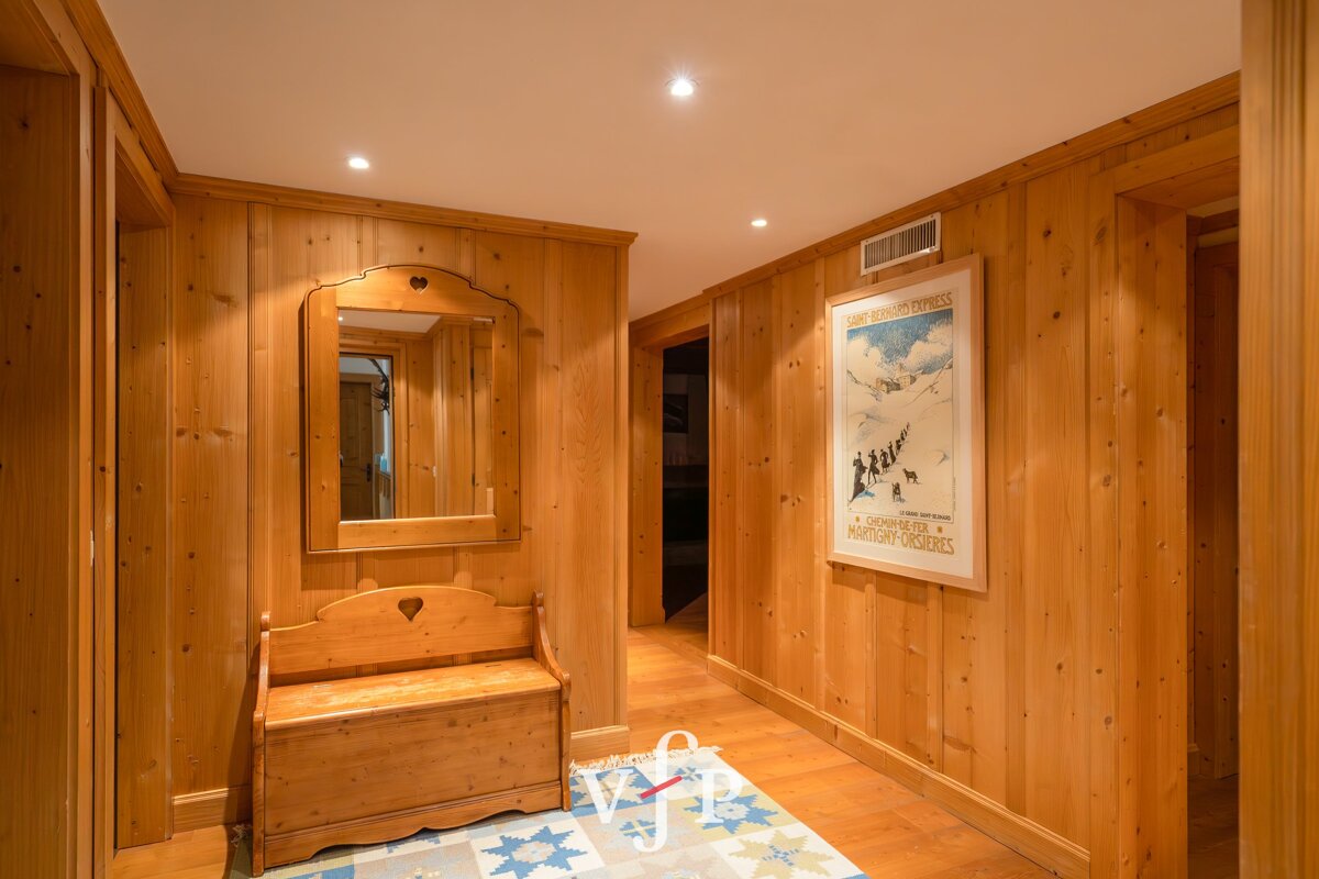 A wooden hallway with a picture of skiers on the wall