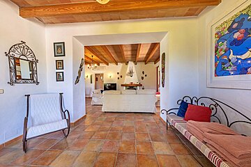A living room with a white couch and a fireplace