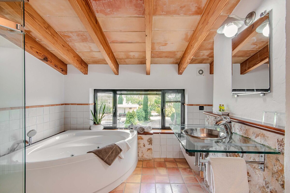 A bathroom with a jacuzzi tub and a sink